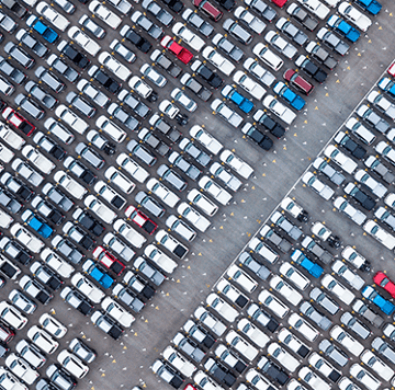 Large parking lot of vehicles overhead shot